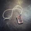 Copper tag stamped with Windy Raven Logo with jump ring and hemp cord