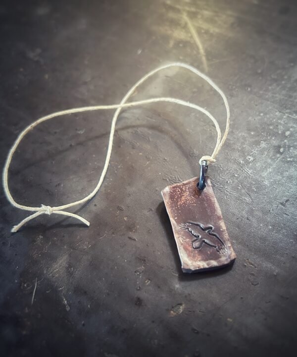 Copper tag stamped with Windy Raven Logo with jump ring and hemp cord