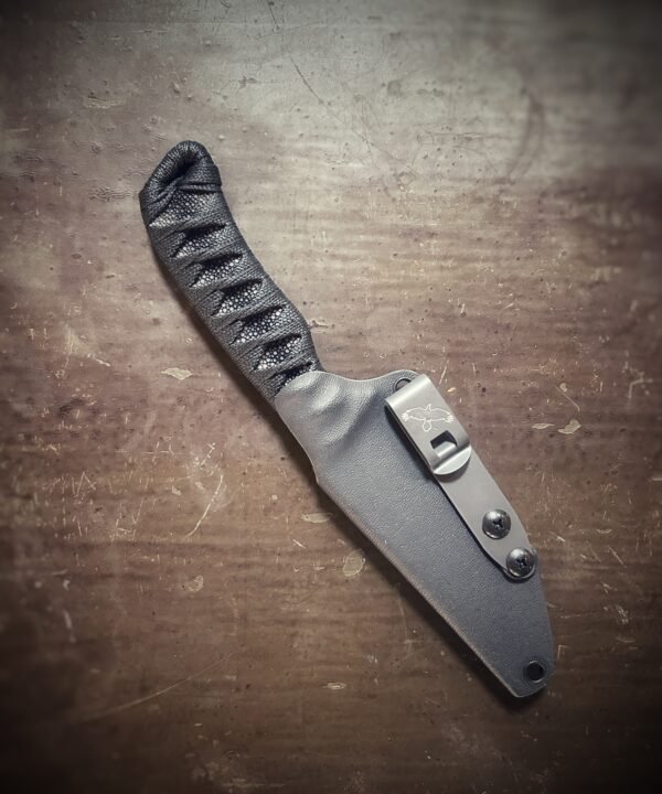 Anathema with polished stingray and black wrap in sheath