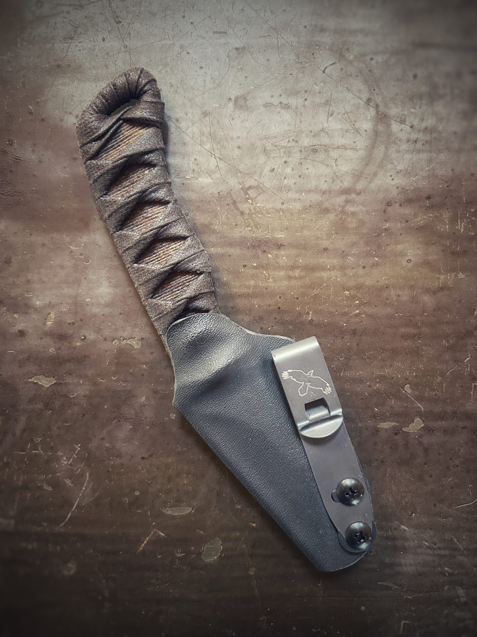 Corax with brown wrap over burnt jute in sheath.