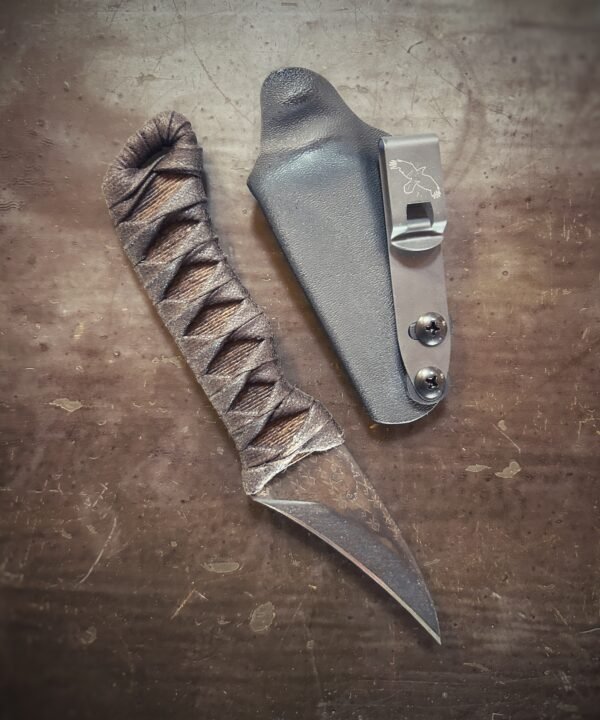 Corax with natural heat treat and brown wrap over burnt jute out of sheath. Runes etched into blade.