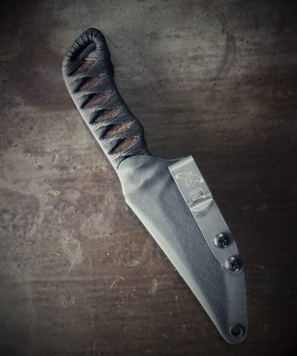 Bidirectional serrated Erinyes with matte blade and burnt jute and black wrap in sheath