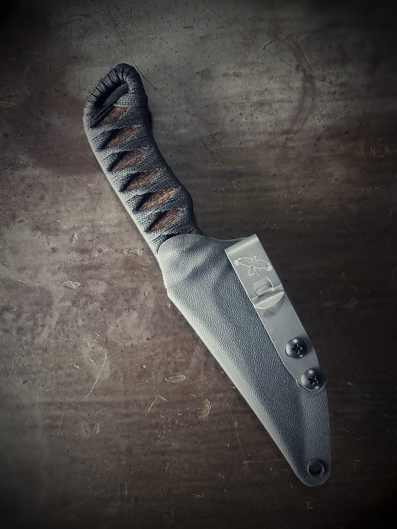 Bidirectional serrated Erinyes with matte blade and burnt jute and black wrap in sheath