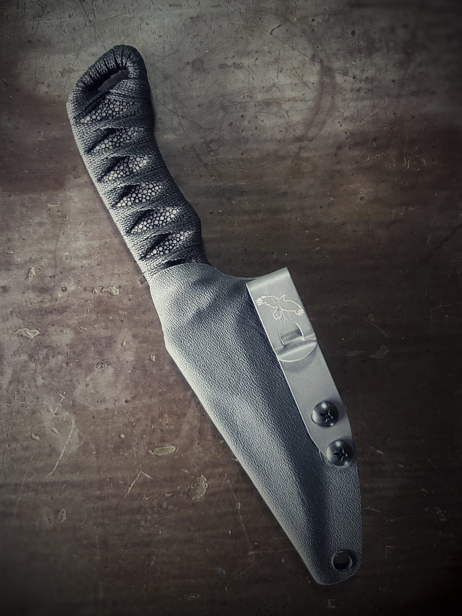 DE Erinyes with colorful heat treat blade and polished stingray and black wrap in sheath