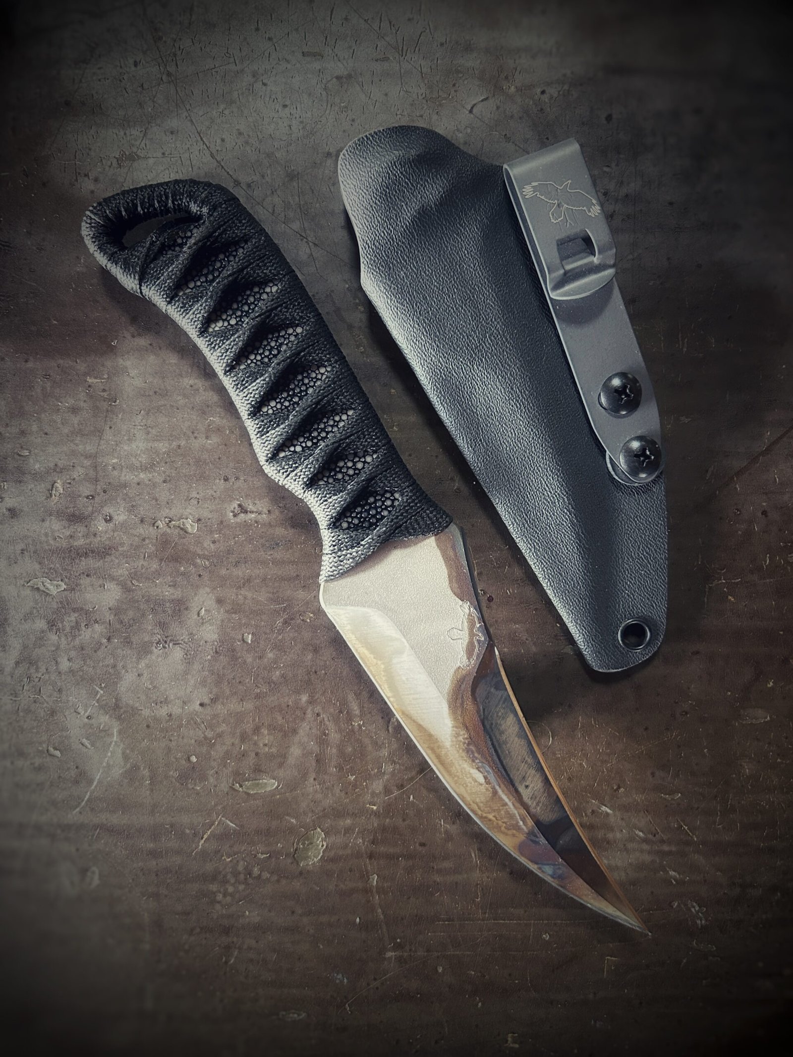 DE Erinyes with colorful heat treat blade and polished stingray and black wrap with sheath