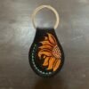 Carved AirTag Fob with black background and carved sunflower
