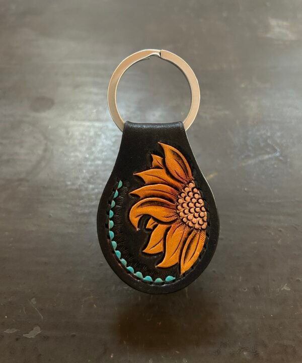 Carved AirTag Fob with black background and carved sunflower