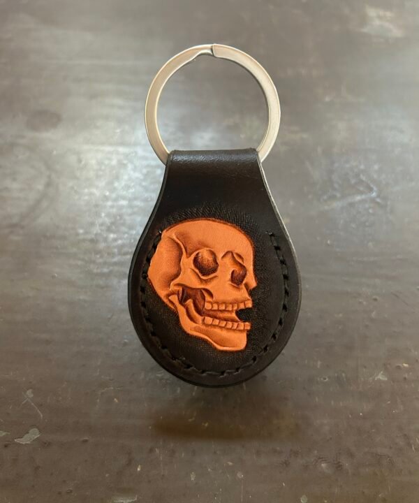 Carved AirTag Fob with black background and carved skull