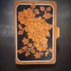 Notebook with modern botanical carving. black and tan with a white background
