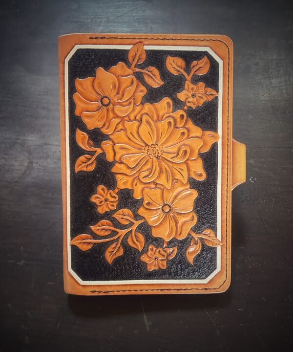Notebook with modern botanical carving. black and tan with a white background