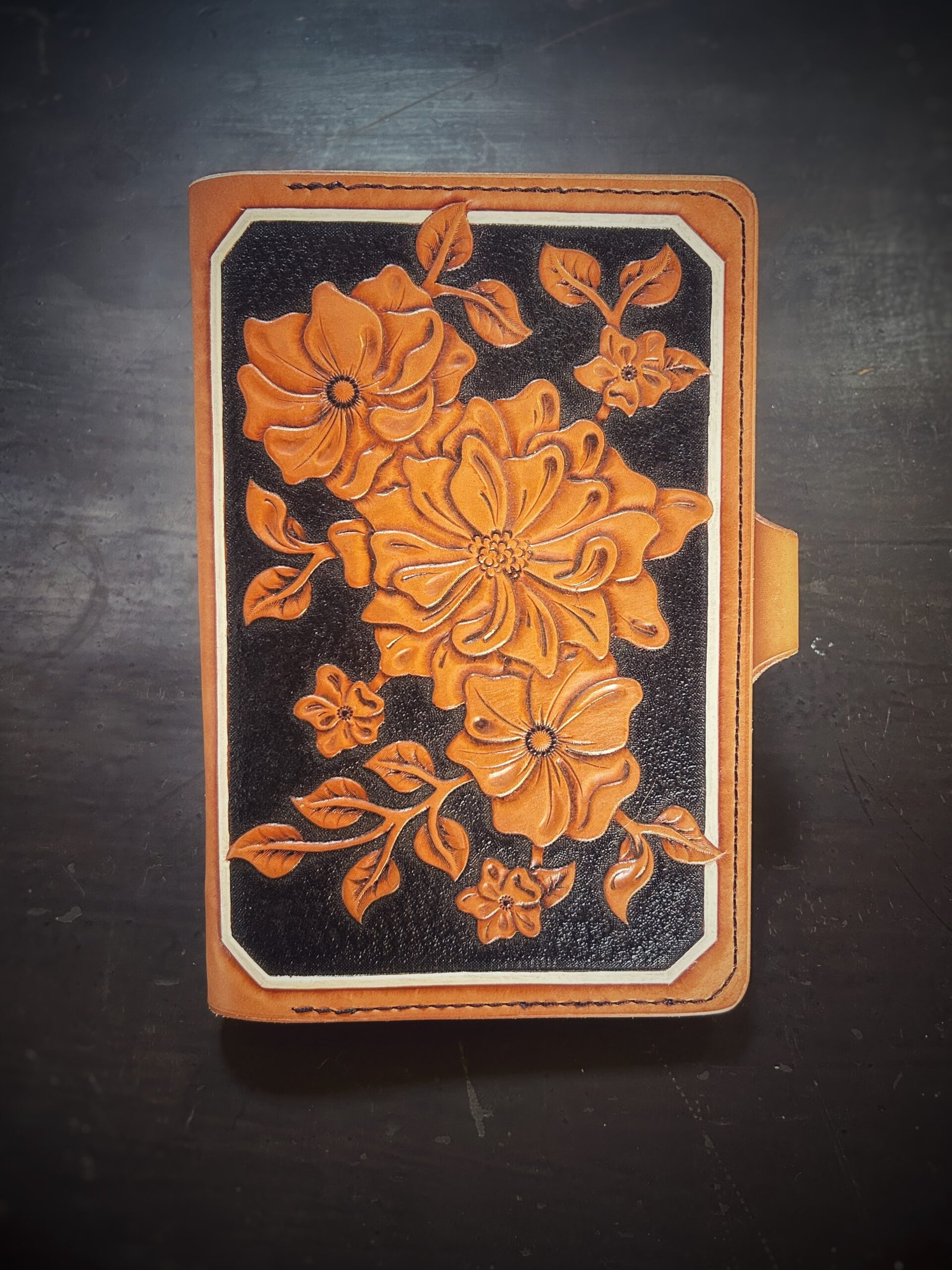 Notebook with modern botanical carving. black and tan with a white background
