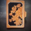 Notebook with modern botanical carving. black and tan with a white background
