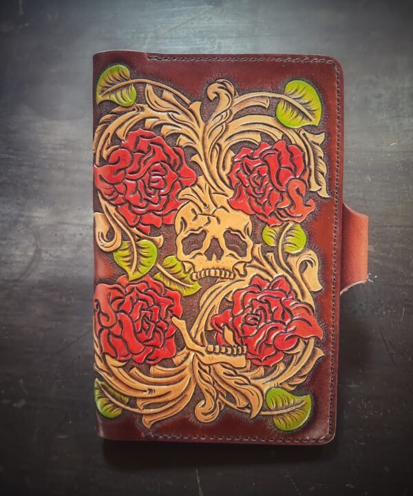 Notebook with 4 roses and a skull in a Western floral design on a brown background