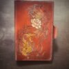 Notebook, refillable. Brown background with two koi fish and one cream lotus flower.