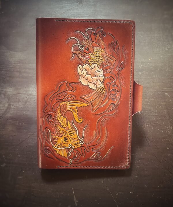 Notebook, refillable. Brown background with two koi fish and one cream lotus flower.