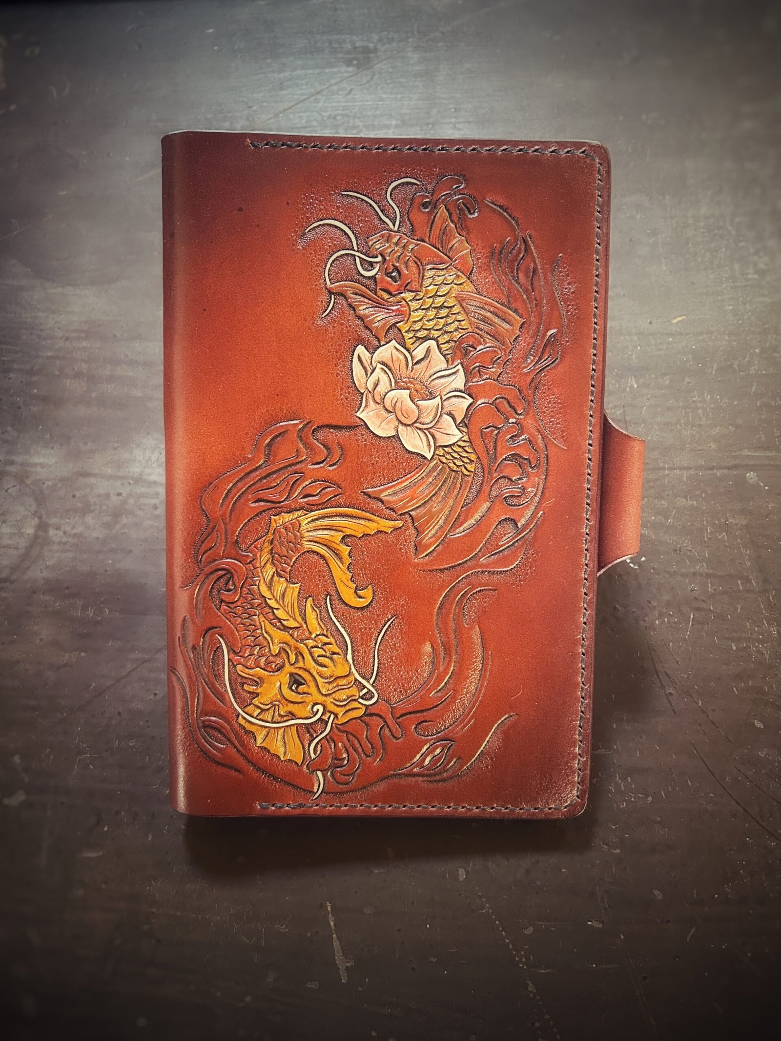 Notebook, refillable. Brown background with two koi fish and one cream lotus flower.