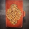 Notebook with 3 flowers in a Western floral design on a brown background