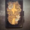Notebook, 2 white roses and a cross on a black background