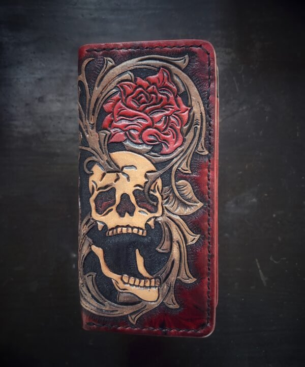 Boulder wallet exterior, red and black marbled background with skull, rose, western scroll work on right side