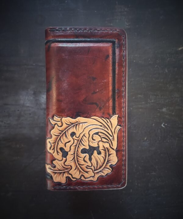 Boulder wallet exterior, brown and black marbled background with black boarder and oak leaves in lower right corner