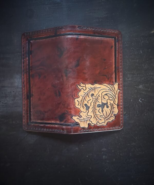 Boulder wallet exterior, brown and black marbled background with black boarder and oak leaves in lower right corner