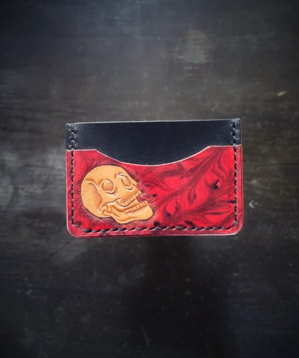 Granite wallet, skull on left side and backgound is red and black marbling