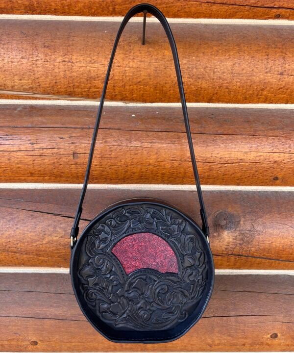 Yellowstone round bag, black western floral with red stingray inset.