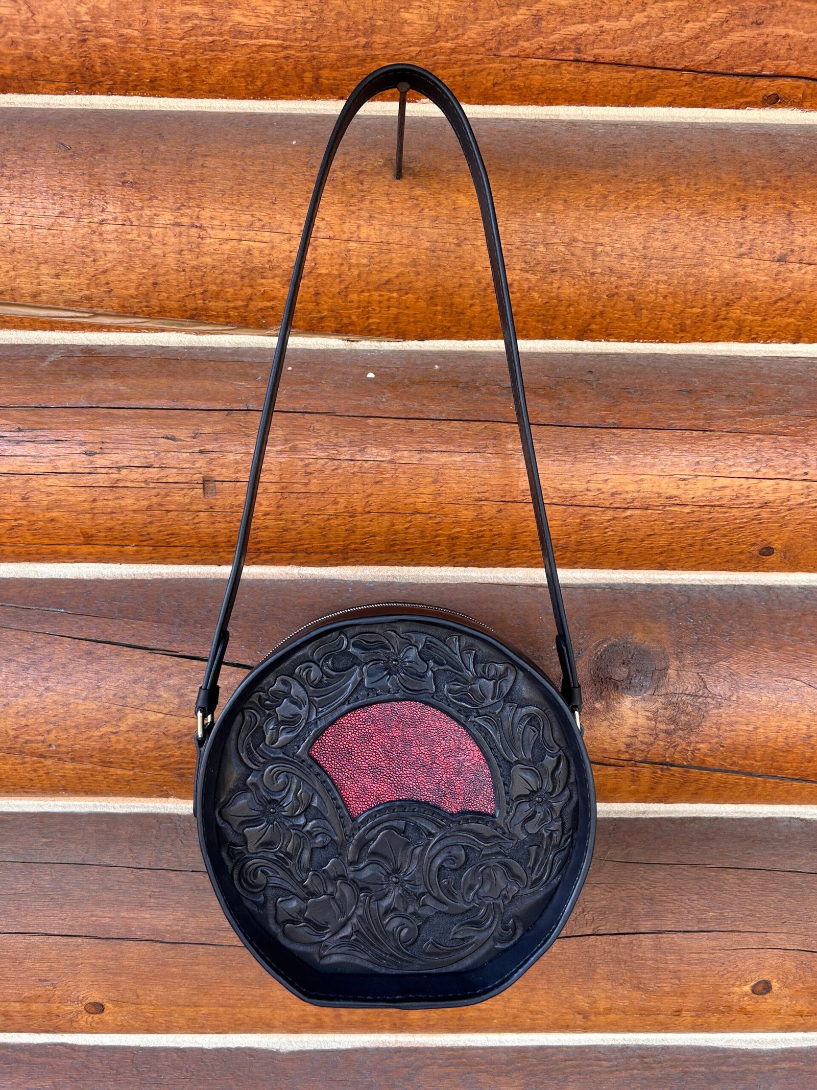 Yellowstone round bag, black western floral with red stingray inset.