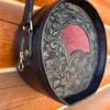 Yellowstone round bag, black western floral with red stingray inset.