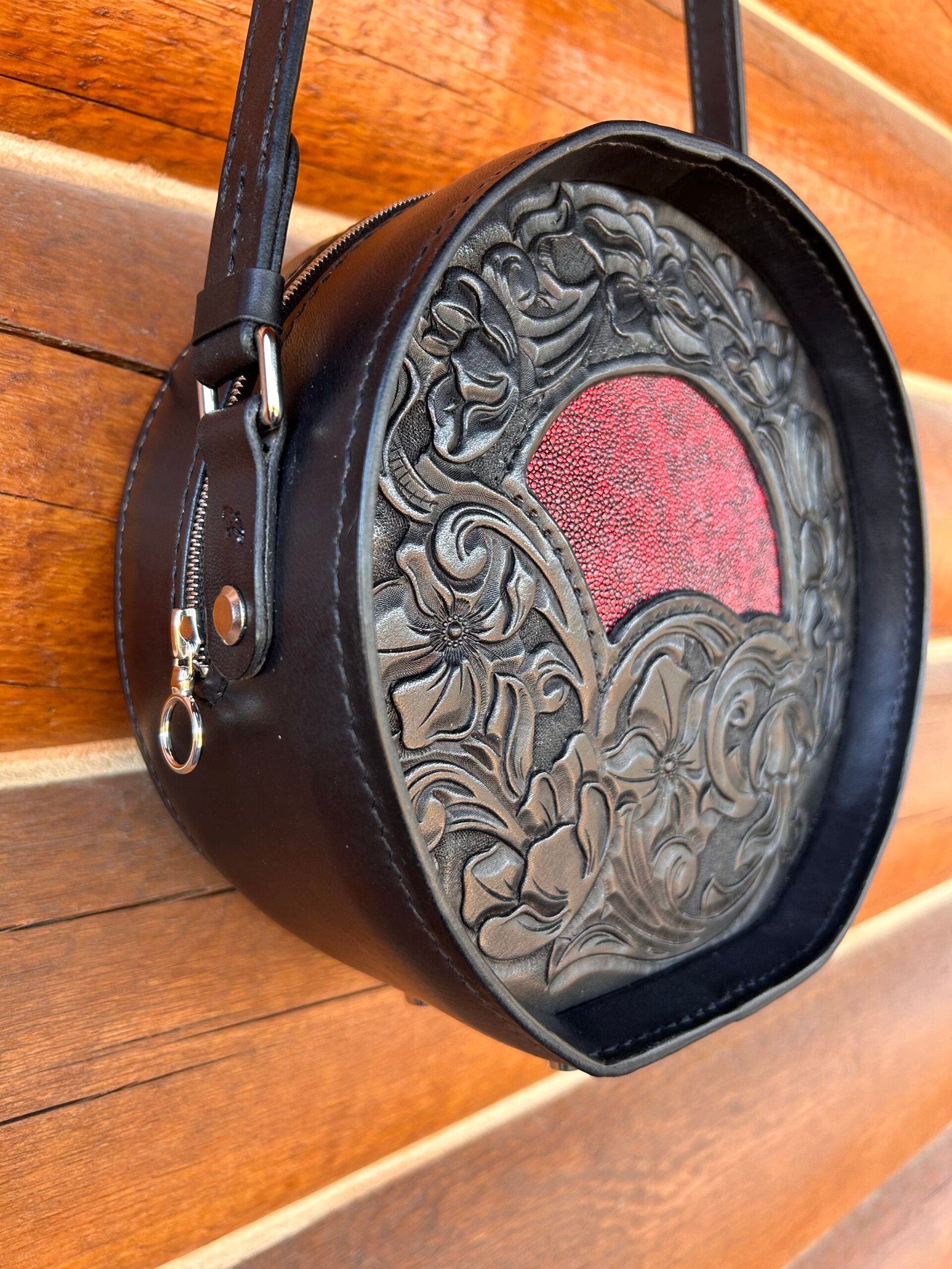 Yellowstone round bag, black western floral with red stingray inset.
